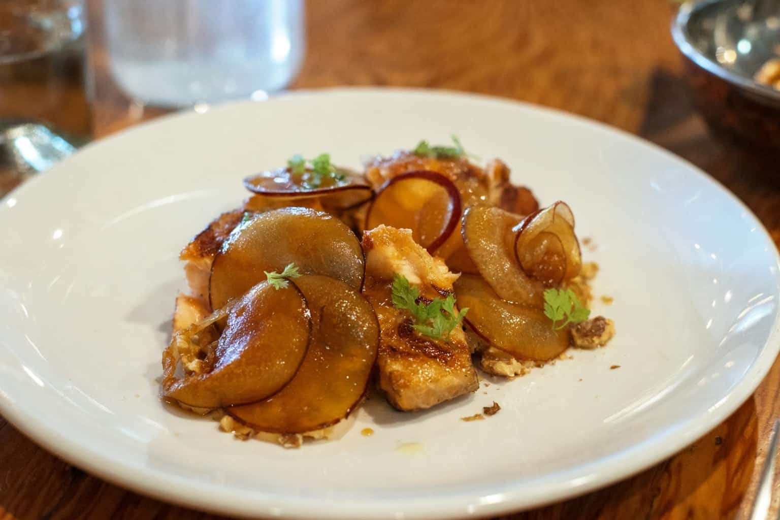 Braised chicken dinner plated with sauce and sides