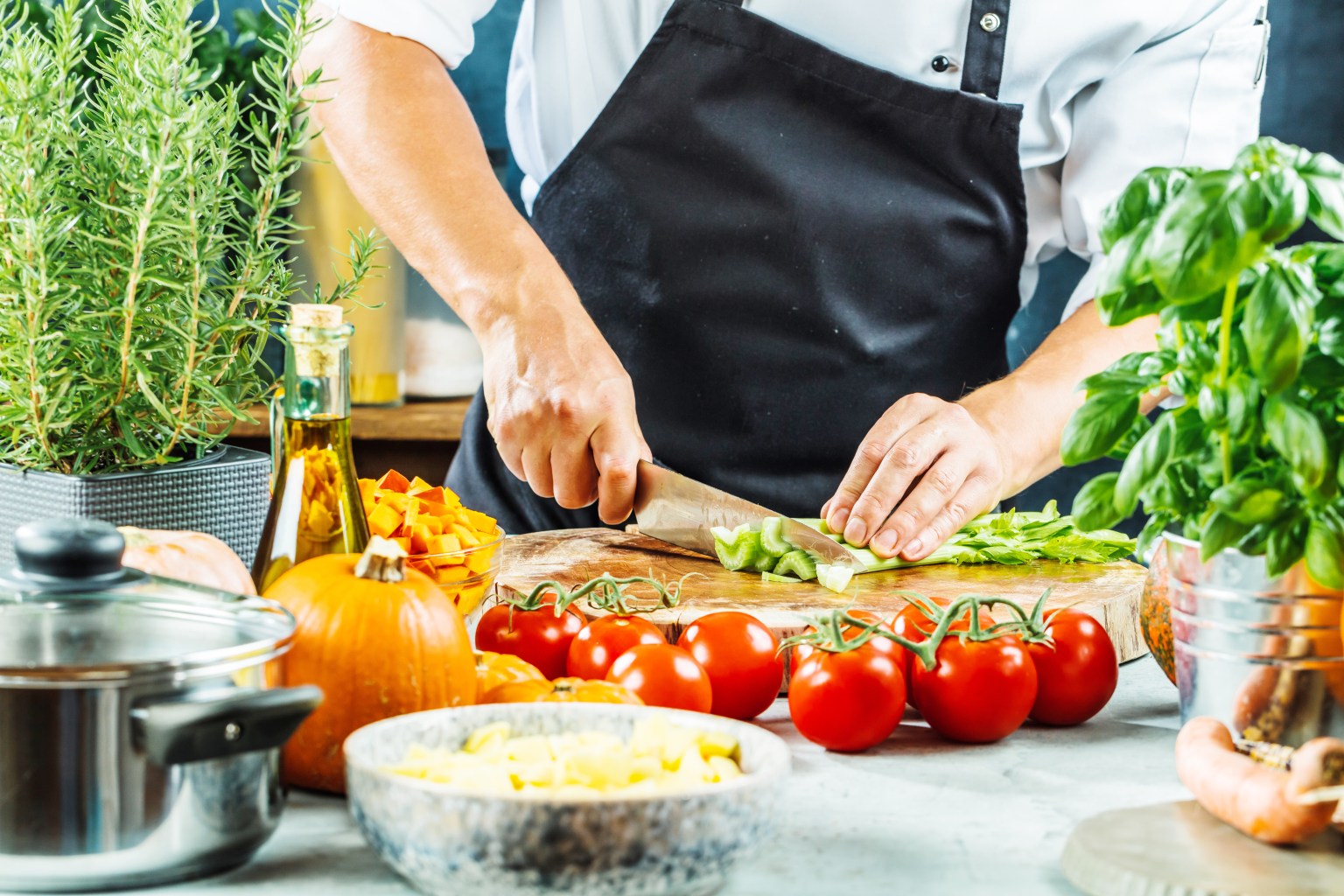 Chef slicing vegetables during careful kitchen work and judgment