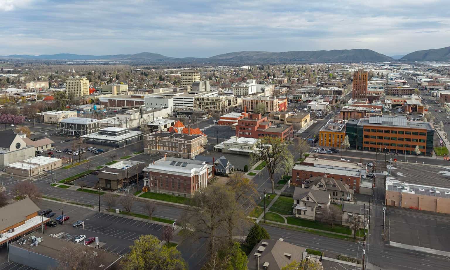 Aerial view of downtown Yakima, Washington, with hills on the horizon