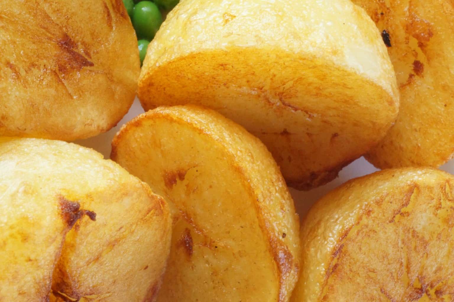 Golden crispy roast potatoes showing protected crust and texture at service
