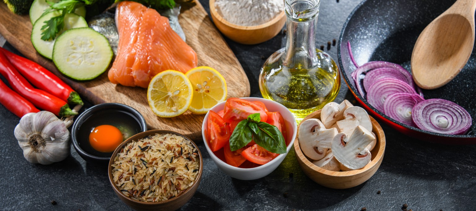 Fresh food ingredients prepared for cooking on a kitchen table