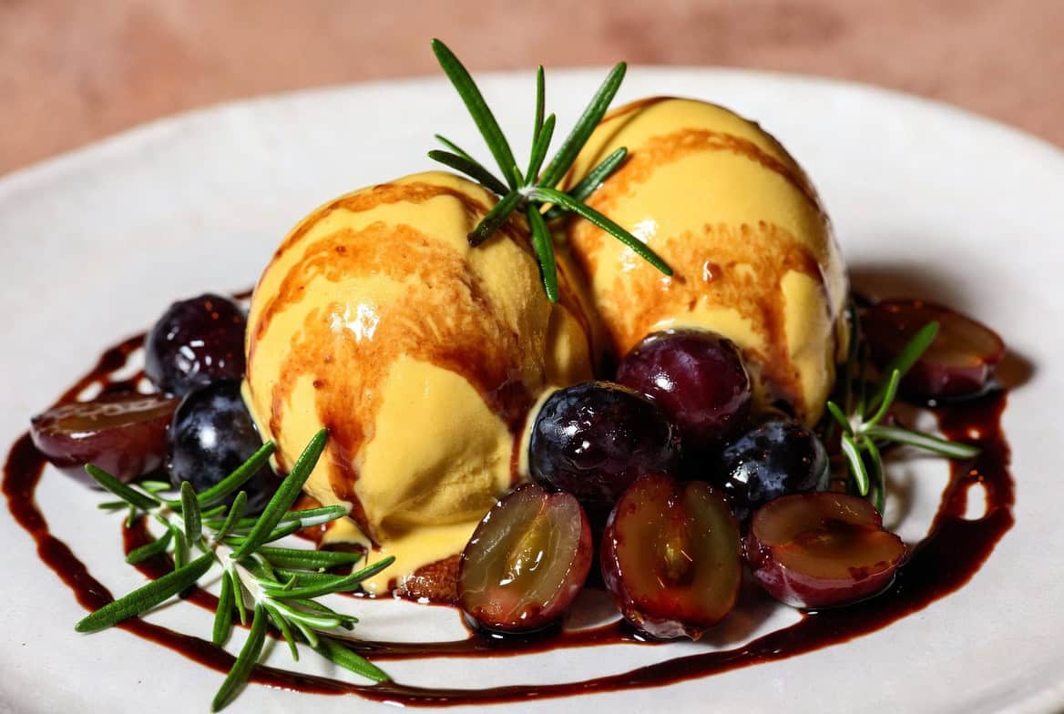 Olive oil gelato sundae with roasted grapes and rosemary caramel