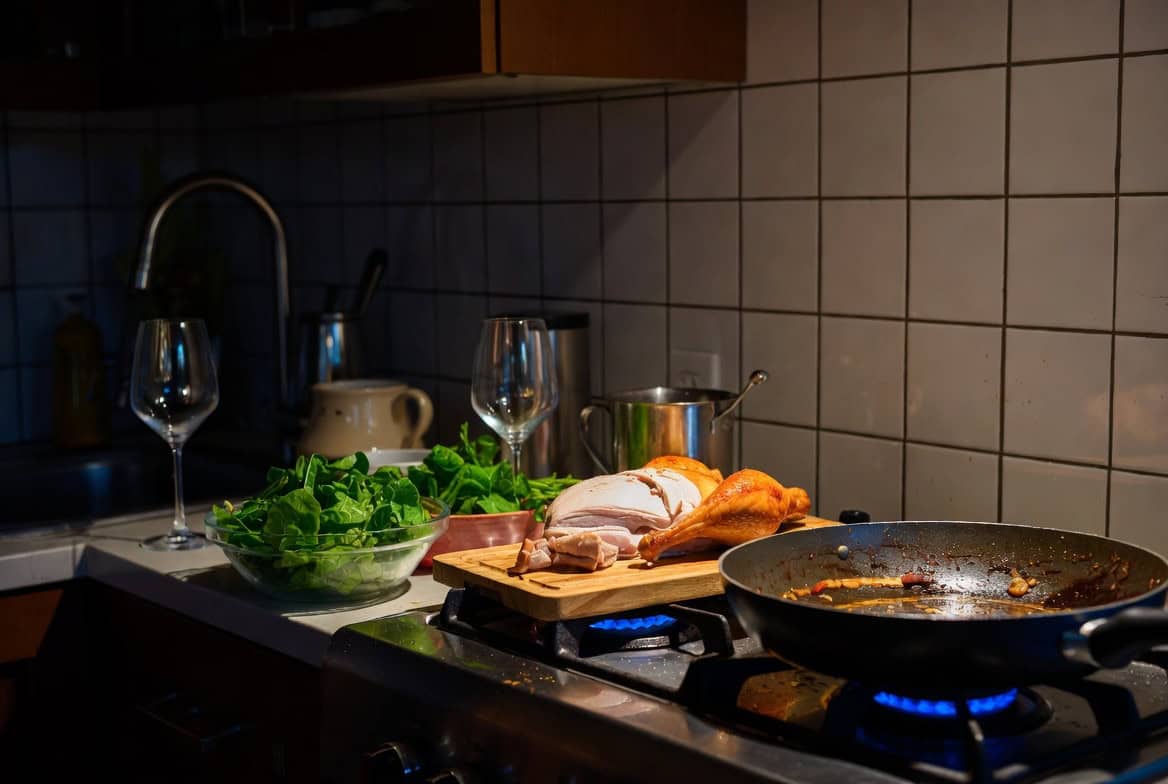 Failed dinner party kitchen with half-roasted chicken, greasy pan, and wilted salad