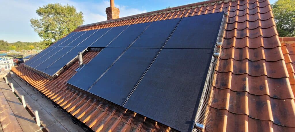 A solar panel on the aspect of a house.