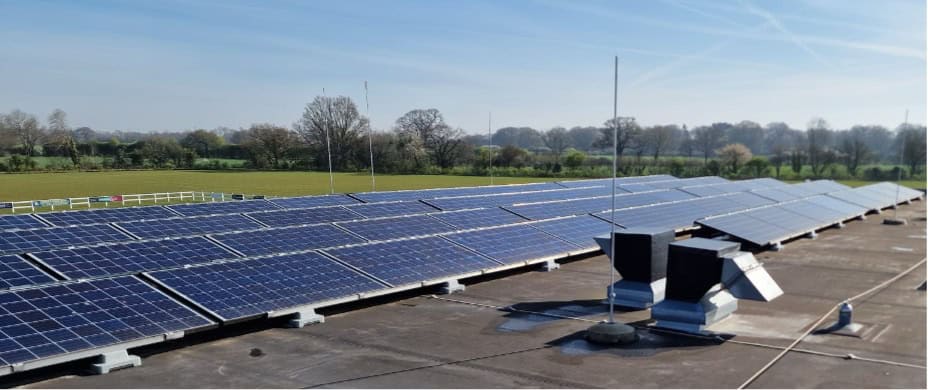 Solar panels installed on a rooftop at Wymondham Rugby Club.