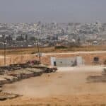 Israeli tanks and armored vehicles around the Gaza border in May. The steel and aluminum used to make weapons are very carbon-intensive to produce. Photo: Ariel Shalit/AP