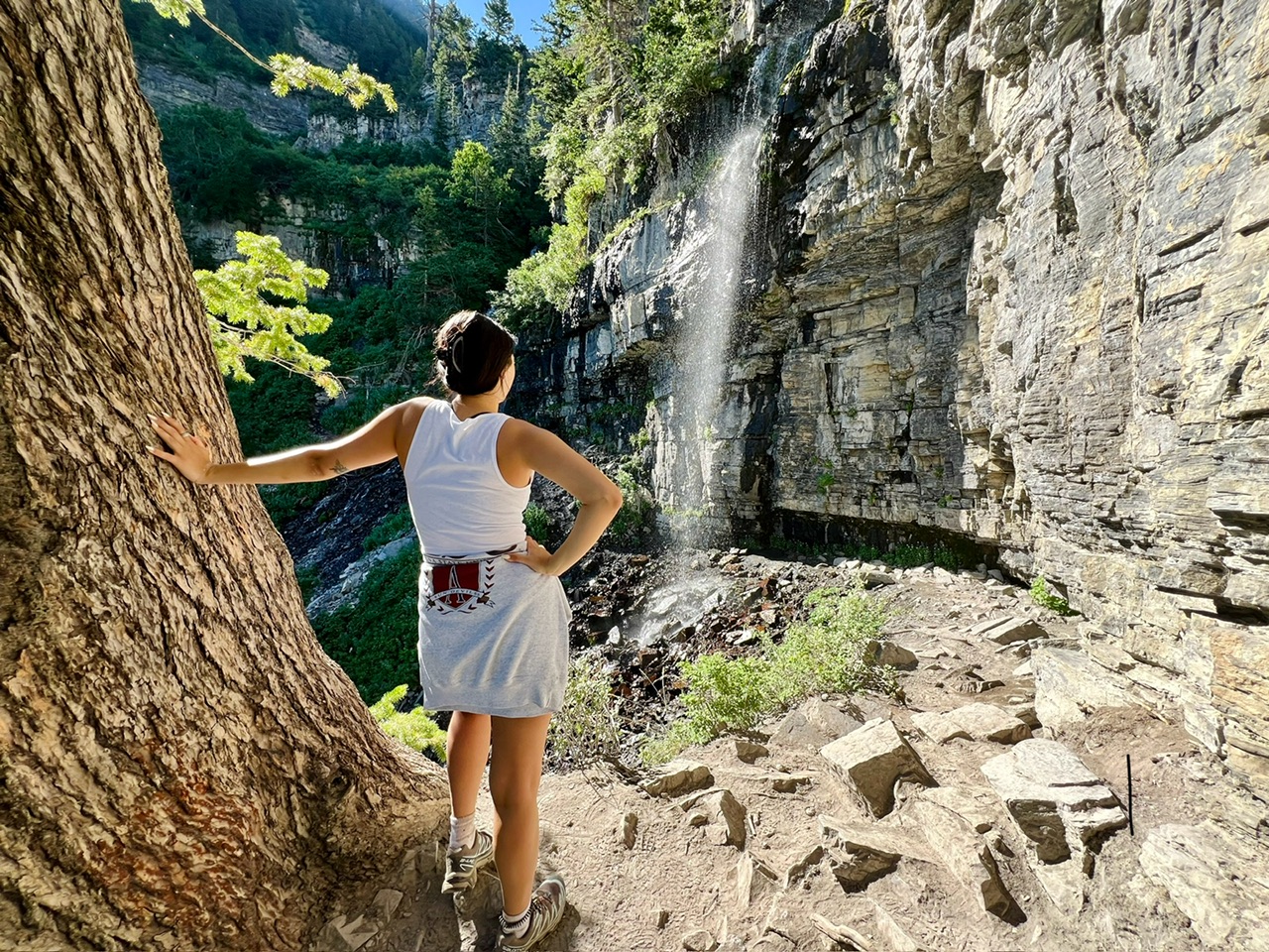 A hiker admires Scout Falls in Utah