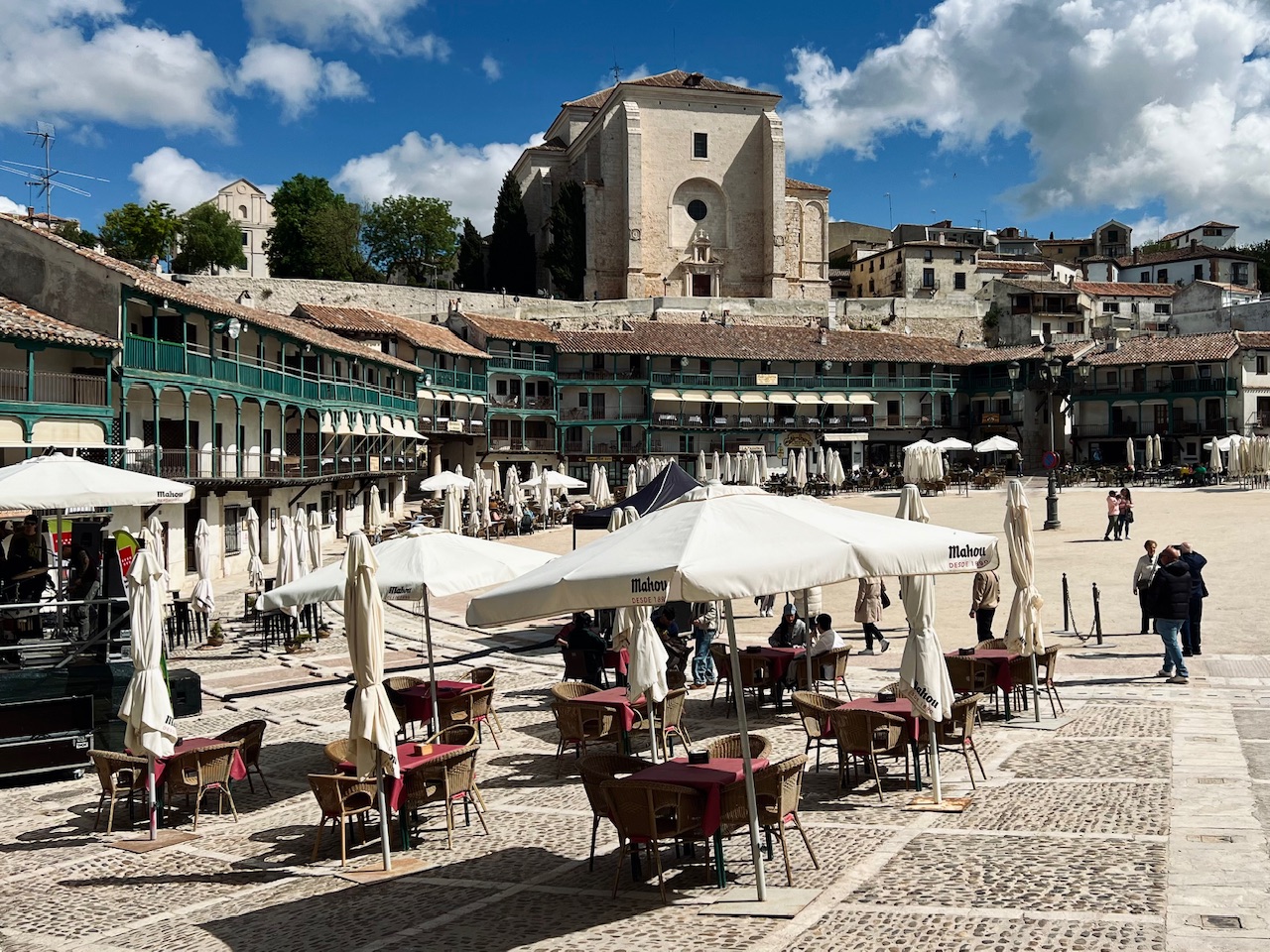 Plaza Mayor in Chinchon Spain with dining tables and the town church