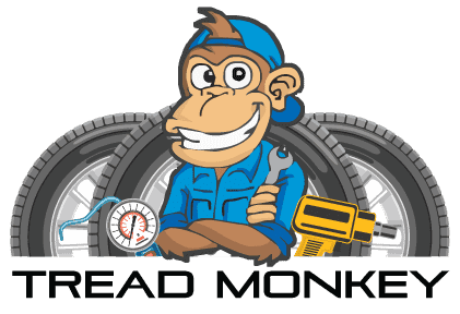 Tread Monkey technician with tools and tires for vehicle maintenance.