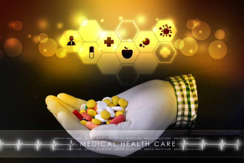 picture showing a hand holding a variety of pills