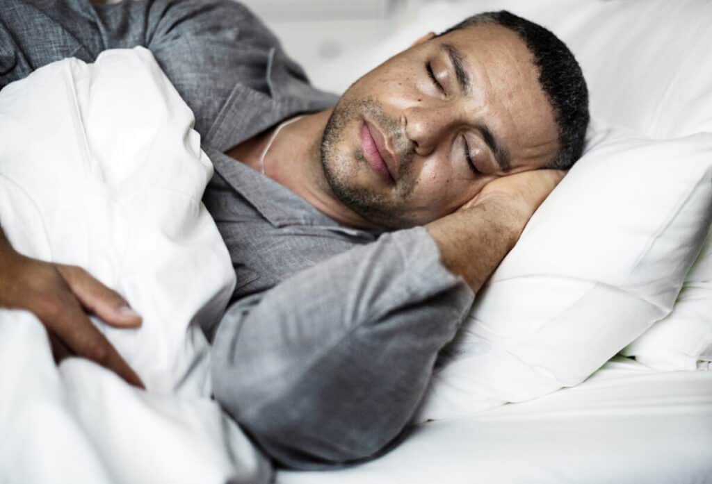 A man sleeping on a bed