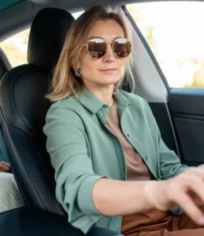 A lady driving an electric vehicle