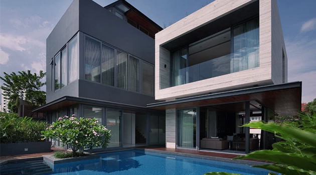 Modern minimalist house with sleek architecture and large glass windows, featuring a private pool and lush landscaping. Perfect for contemporary home design and luxury living.