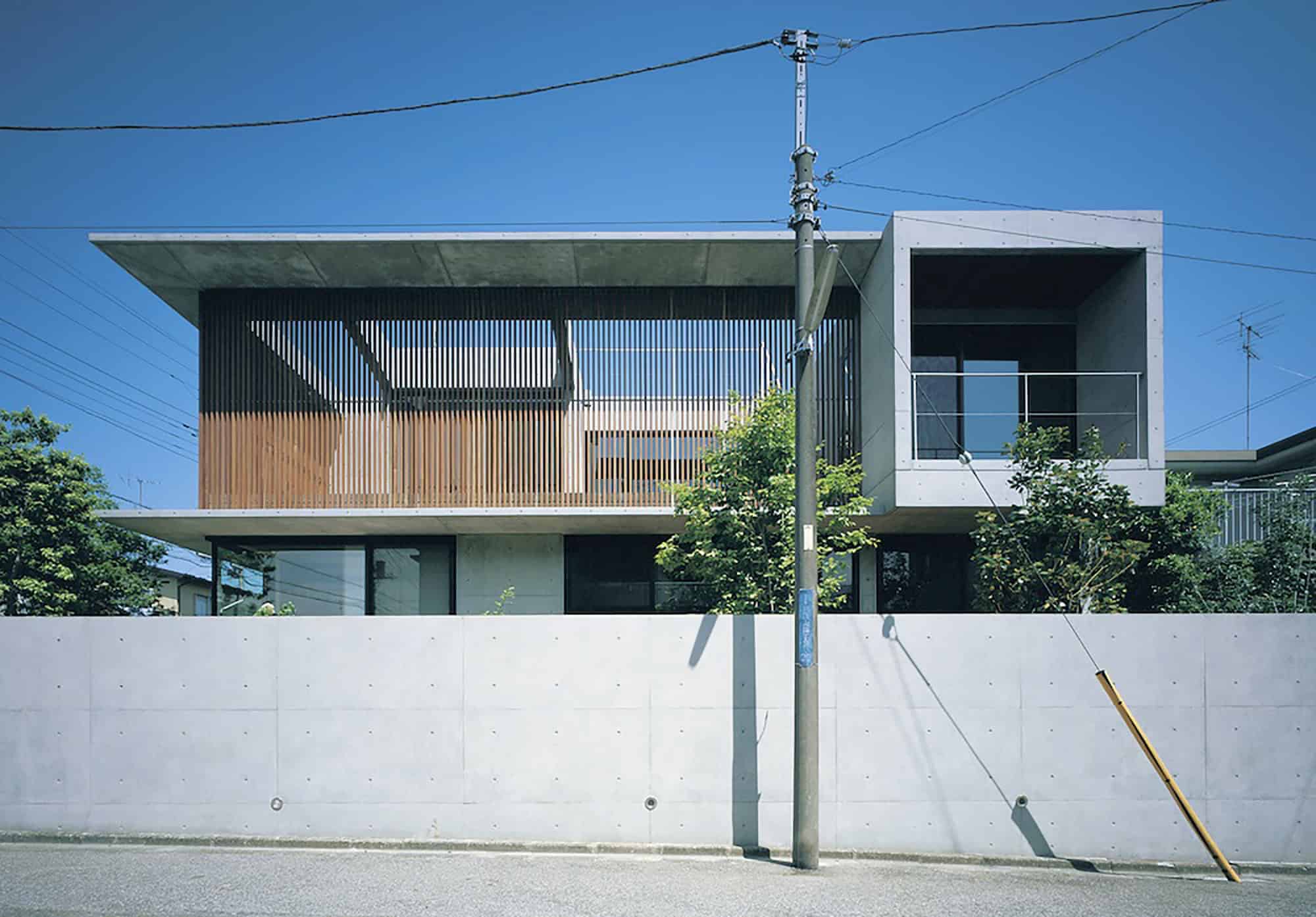 Contemporary modern house with minimalist architectural design featuring clean lines, concrete and wooden elements, and large windows. Ideal for modern architecture art designs and urban residential aesthetics.