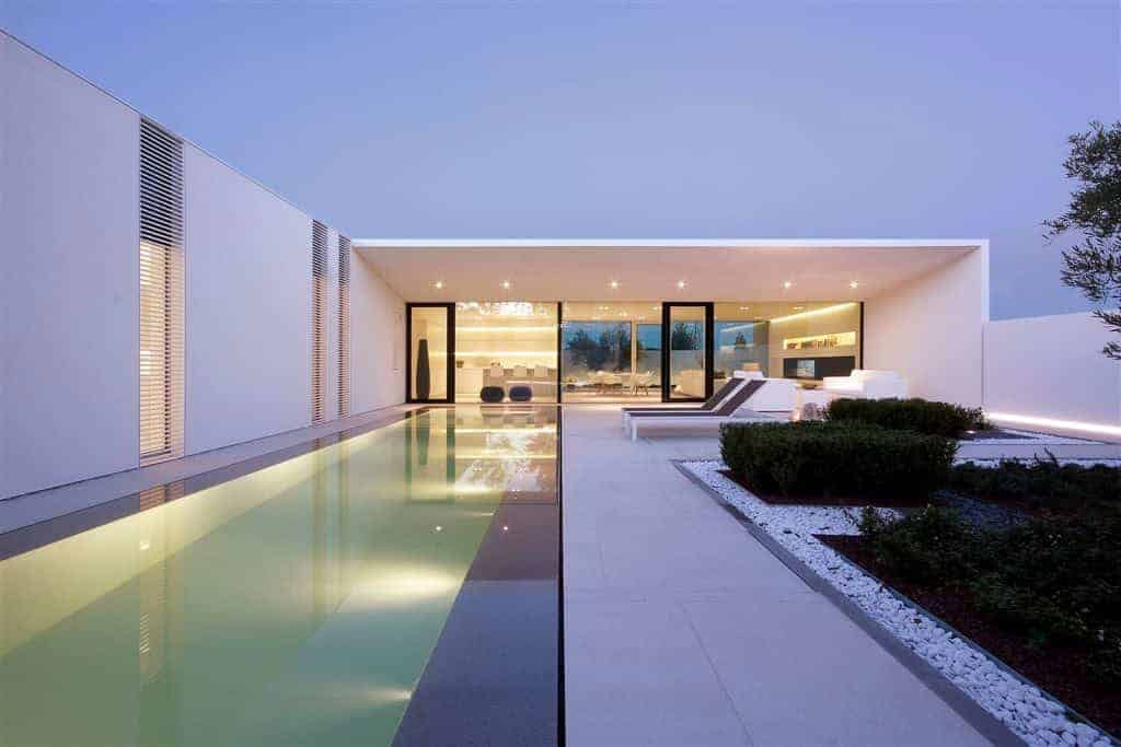 Sleek modern luxury villa with infinity pool and contemporary exterior design, emphasizing minimalist architecture and outdoor living space, perfect for luxury real estate enthusiasts.