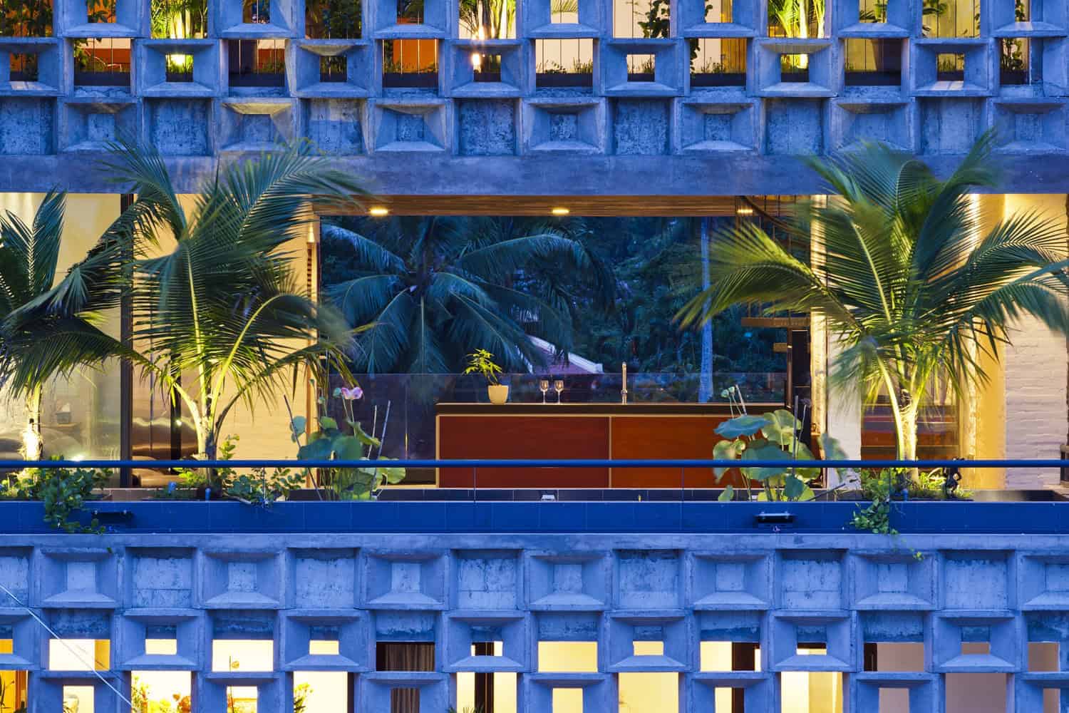 Modern tropical villa with lush greenery and contemporary architecture showcasing innovative design and tropical home ideas.