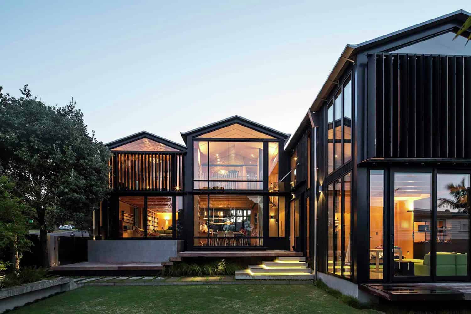 Sleek modern house with black metal framing, large glass windows, and contemporary architectural design, showcasing stylish architecture art designs and innovative home exterior ideas.