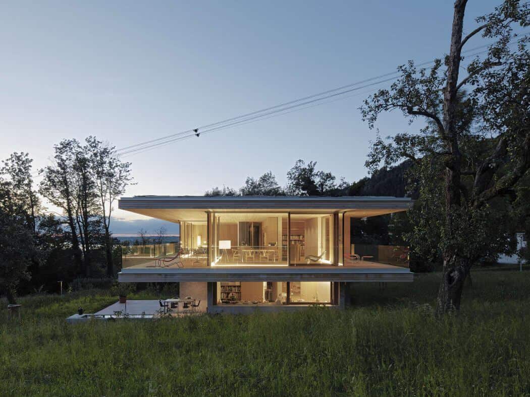 Modern glass and steel house with open-concept design, large windows, and scenic surroundings, showcasing innovative architecture and contemporary home design.