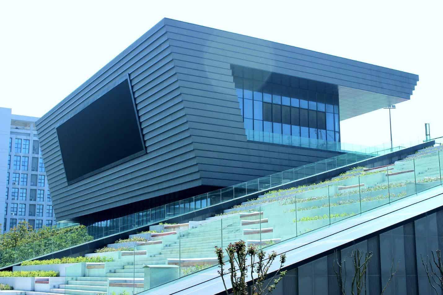 Futuristic modern architectural building with sleek lines and glass façade, innovative design, contemporary urban architecture, and stunning exterior aesthetics.