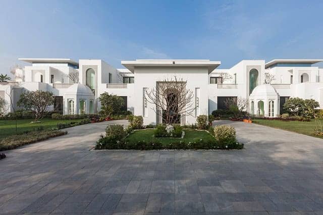 Modern luxury white villa with contemporary architectural design, featuring clean lines, spacious layout, and landscaped gardens, ideal for upscale residential living.