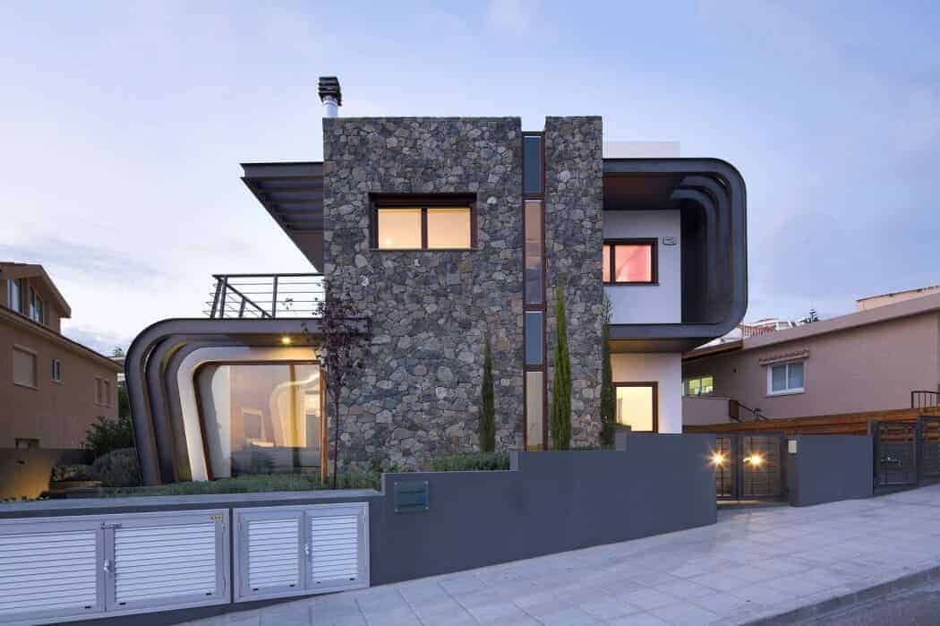 Contemporary modern house with unique architectural design featuring stone facade and curved black cornices, urban residence with sleek curb appeal and innovative structure.