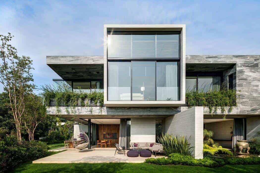 Modern luxury house with contemporary architecture, large glass windows, and lush outdoor garden, showcasing innovative residential design and stylish outdoor living spaces.