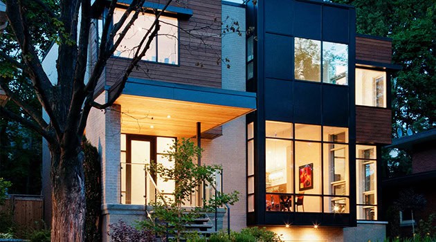 Contemporary modern house with expansive glass windows and wooden accents, showcasing innovative architecture and sleek design.