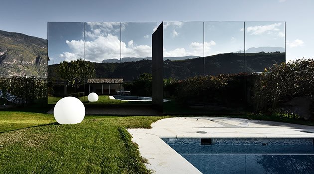 Modern minimalist glass house reflecting mountain landscape with landscaped garden and pool, contemporary architecture design, sleek and stylish exterior, luxury residence architecture art designs.