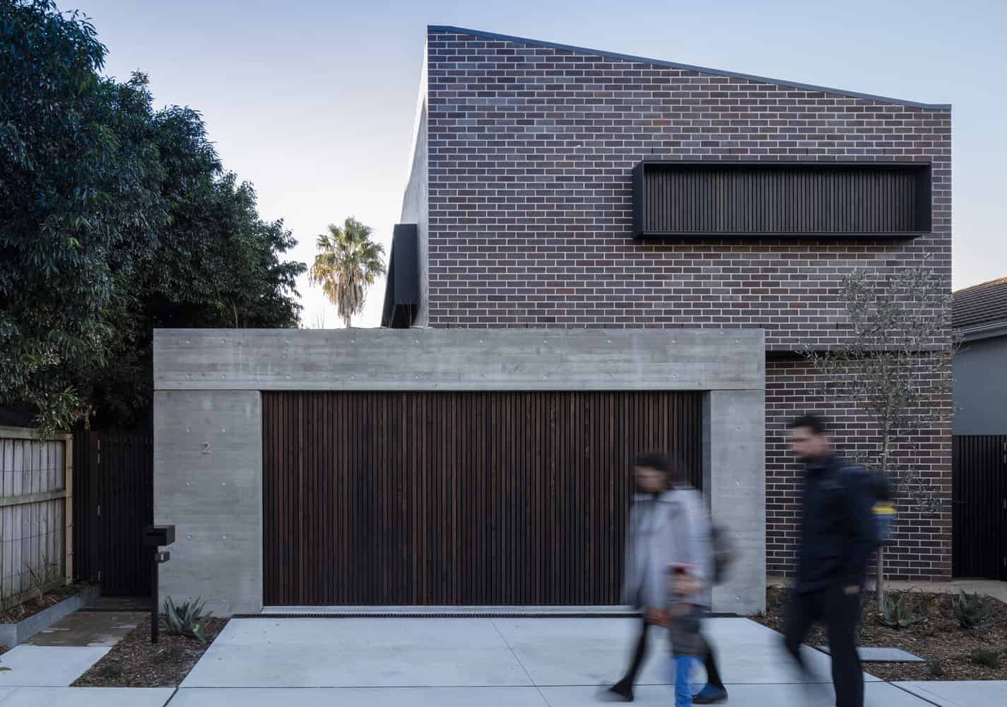 Modern contemporary house with brick and concrete facade, sleek design, and minimalist architecture showcasing innovative urban home design.