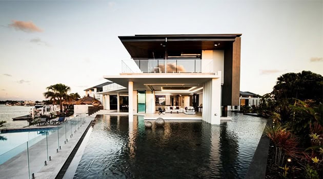 Luxury modern waterfront villa with infinity pool and contemporary architecture design, featuring spacious outdoor living areas and sleek architectural details.