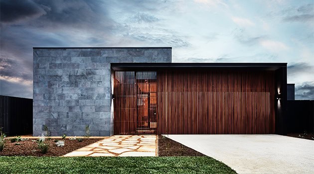 Modern minimalist house with sleek concrete and warm wooden accents, emphasizing contemporary architecture and innovative design.