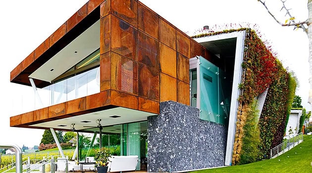 Colorful Modern House with Unique Architectural Design and Green Roof in a lush landscape.