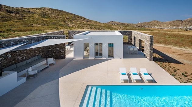 Modern minimalist villa with sleek architecture, outdoor pool, and scenic landscape views, perfect for luxury vacation homes and contemporary residential design.