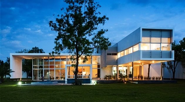 Modern luxury architecture home with sleek glass facades and contemporary design elements at dusk.