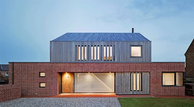 Modern minimalist house design with brick and wood exterior for contemporary architecture projects.