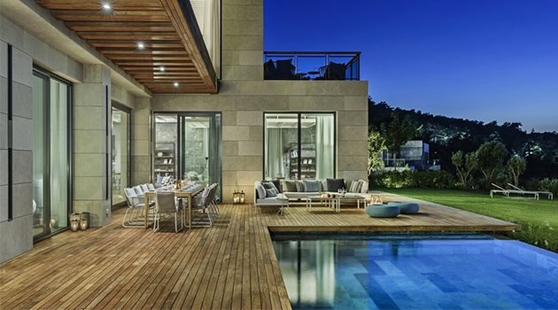 Modern luxury house with outdoor pool and spacious patio featuring contemporary design, outdoor seating, and seamless indoor-outdoor living. Perfect for luxury home architecture and outdoor design.