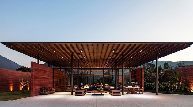 Elegant modern pavilion with wooden roof and glass walls, perfect for outdoor living and entertainment, showcasing contemporary architecture and stylish design elements.