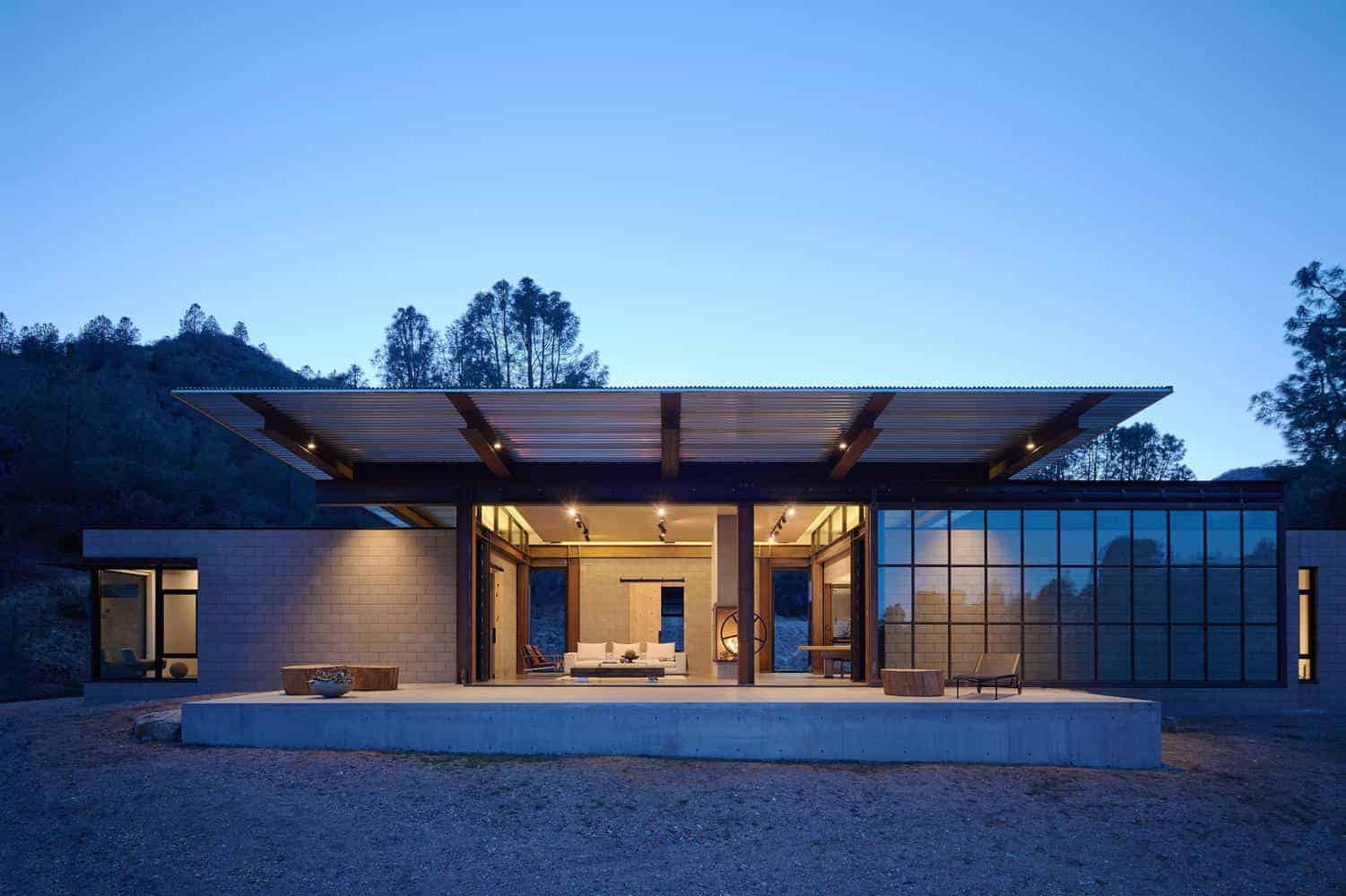 Modern contemporary house with sleek architectural design, open living space, large glass windows, and eco-friendly features set in a scenic natural landscape.