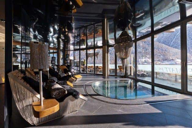 Indoor luxury spa with large glass windows, modern design, relaxing hot tub, elegant lighting, and mountain views, showcasing contemporary architecture and stylish interior decorating.