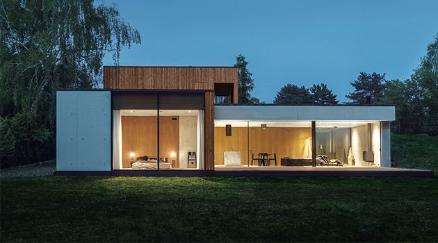 Modern minimalist house with sleek design, large glass windows, and open-plan living spaces showcasing contemporary architecture and innovative home design.