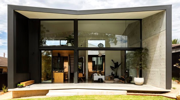 Contemporary modern house with large glass windows and minimalist architectural design, blending indoor and outdoor living spaces, ideal for modern architecture and innovative home design.