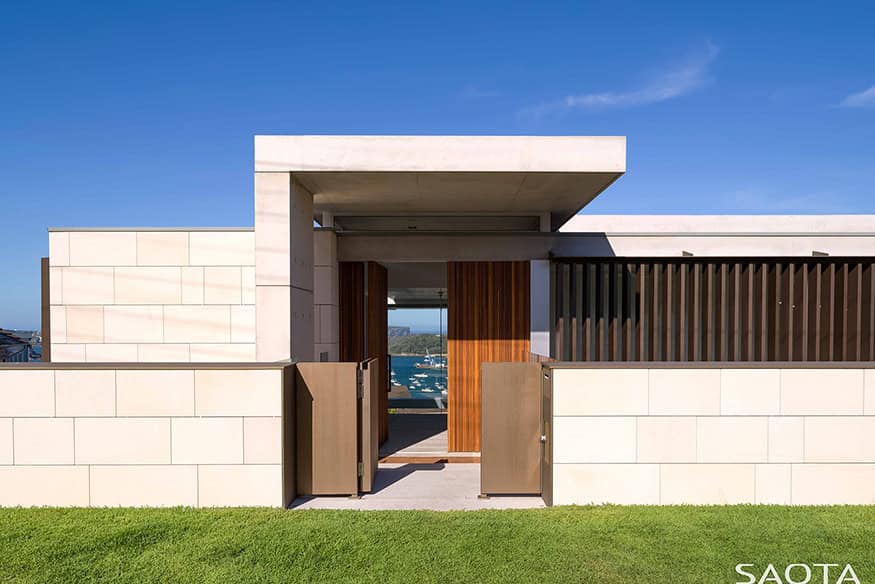 Modern minimalist house with clean concrete walls, wooden accents, and contemporary architectural design showcasing sleek lines and open space.