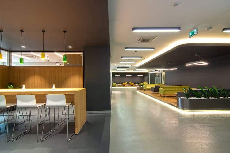 Modern office lobby with contemporary design elements, sleek lighting, and comfortable seating areas showcasing innovative architectural and interior design for functional workspace aesthetics.
