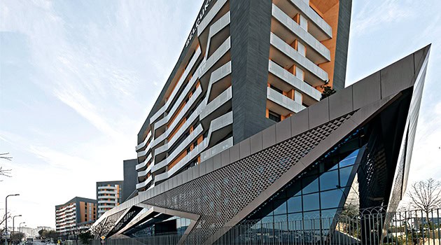 Futuristic modern building architecture with striking geometric design and innovative facade, showcasing contemporary urban architecture and creative building art.