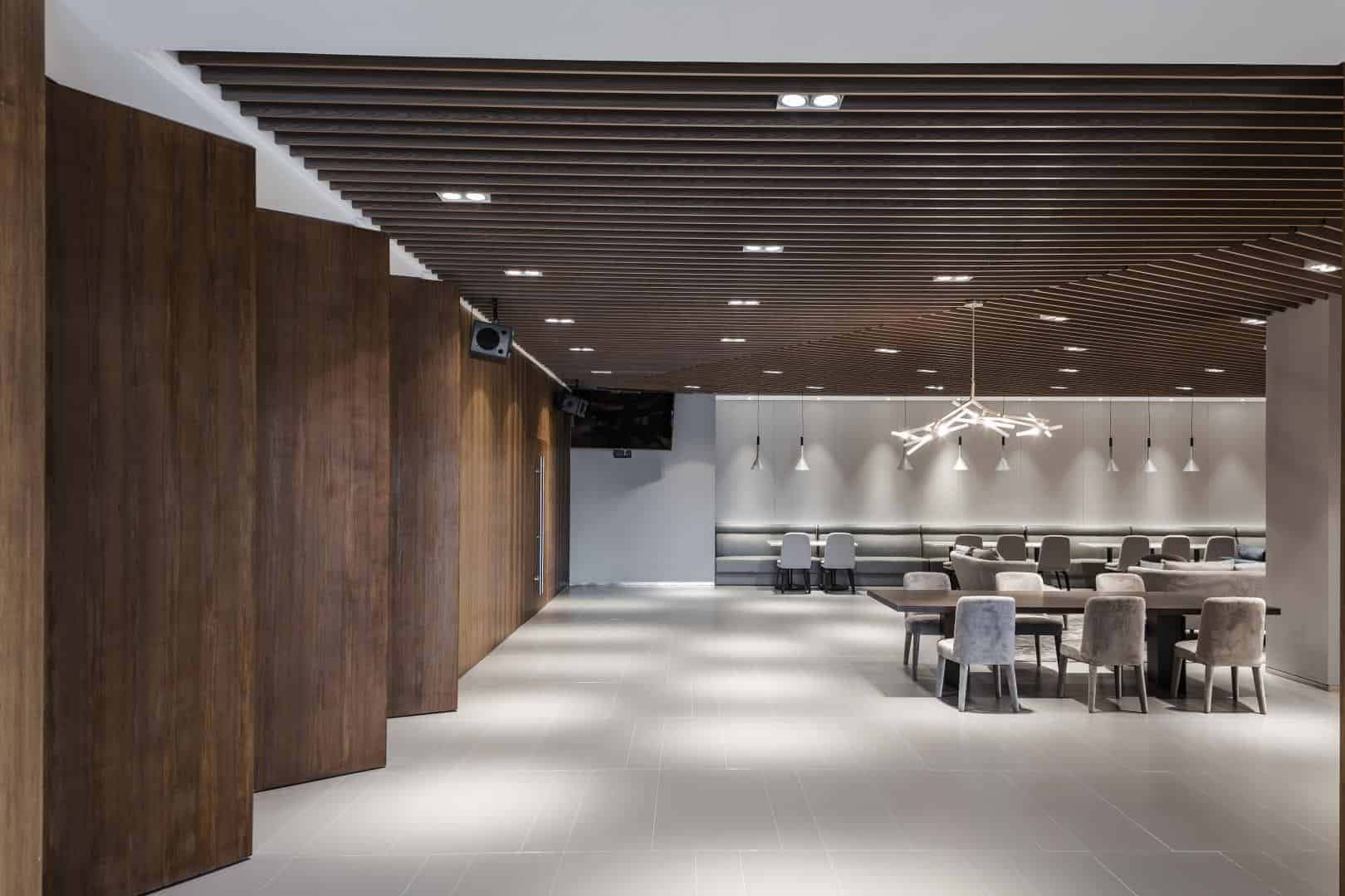 Sleek modern interior design with minimalist furniture, unique lighting fixtures, and wooden accents creating a sophisticated space. Perfect for contemporary architecture and interior design inspiration.