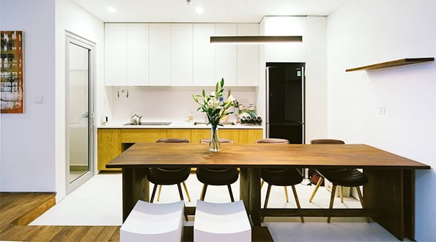 Modern minimalist kitchen design with sleek white cabinetry, wooden accents, and functional furniture for contemporary home interiors.