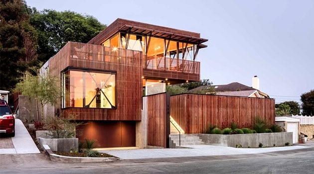 Modern luxury wooden house with large glass windows, outdoor balcony, and contemporary architectural design, showcasing innovative residential architecture and eco-friendly building materials.