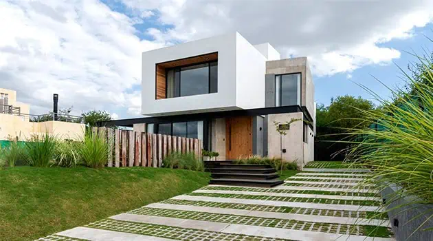 Modern minimalist house exterior with clean lines, large windows, and contemporary architectural design, showcasing innovative use of materials and integration with surrounding landscape.