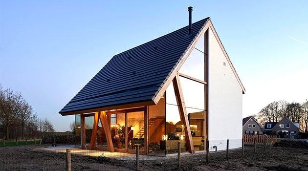 Contemporary modern house with large glass windows, minimalist design, and unique architectural structure showcasing innovative home design ideas.