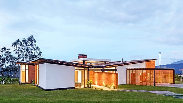 Modern contemporary house with sleek design and expansive glass doors, showcasing innovative architecture art designs and sustainable building materials.